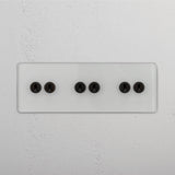 Functional Six-Position Triple Toggle Switch in Clear Bronze for Light Switching on White Background